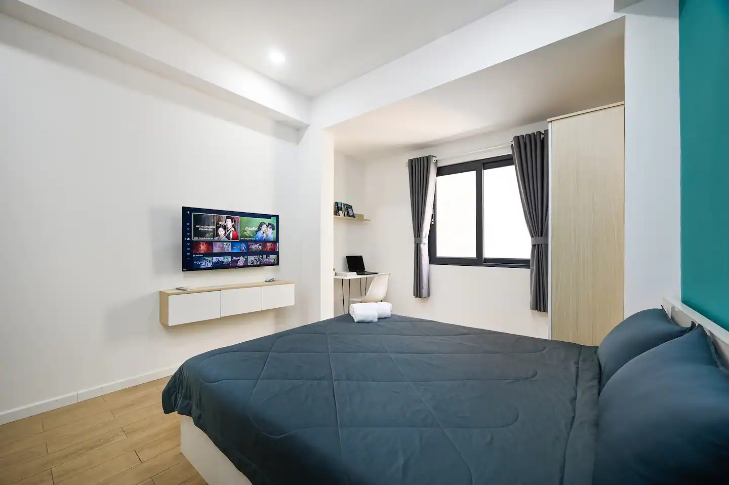 Studio 2.5 interior with queen bed and kitchenette